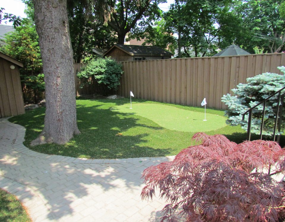 golf green blends nicely between trees and landscaping