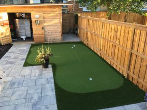 Off patio golf green keeps the backyard open for kids 