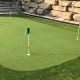 Stunning golf green and fringe turf with large Armour stone wall