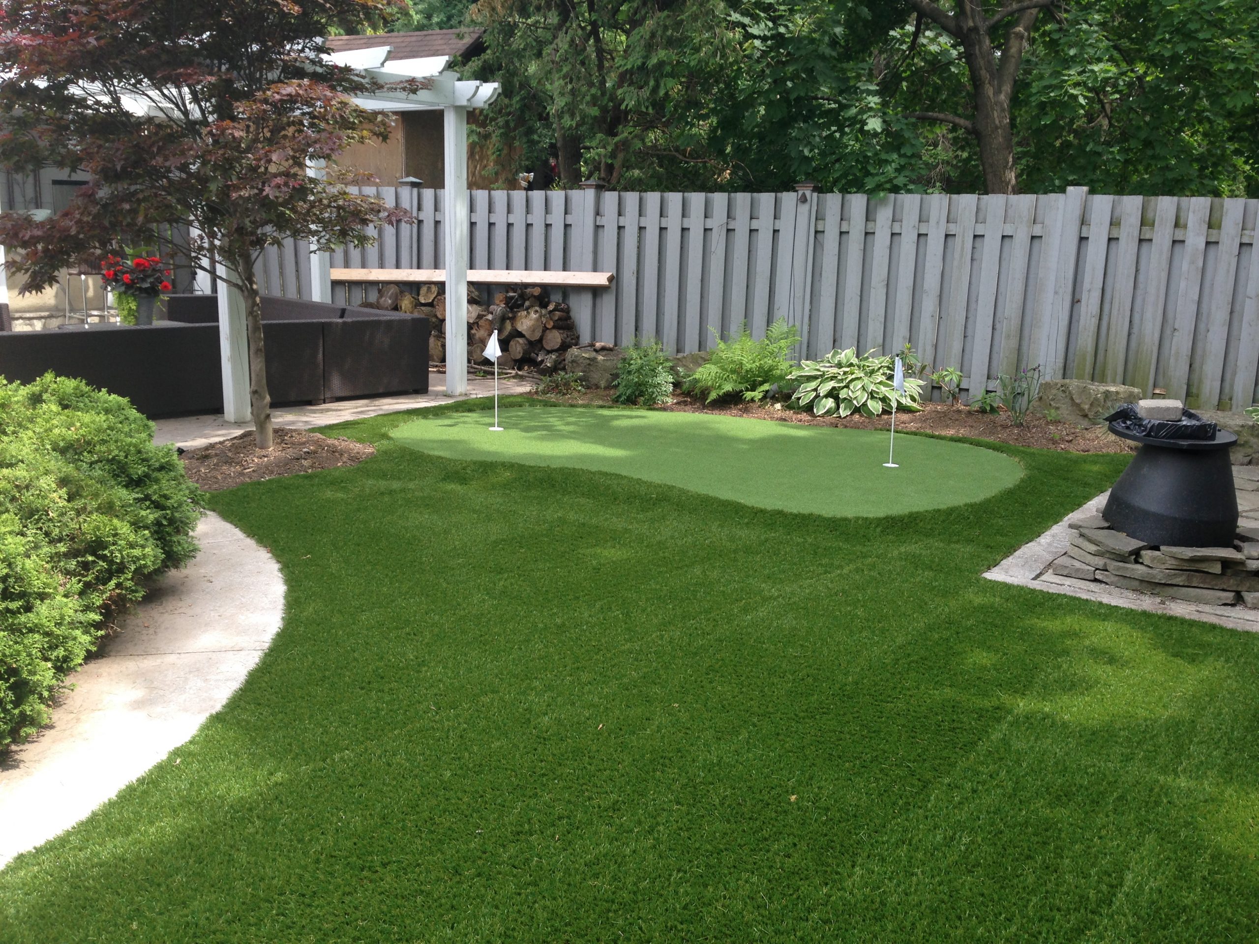 Backyard artificial grass makeover with small golf green